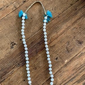 Anthropologie white beaded necklace with teal tassels.